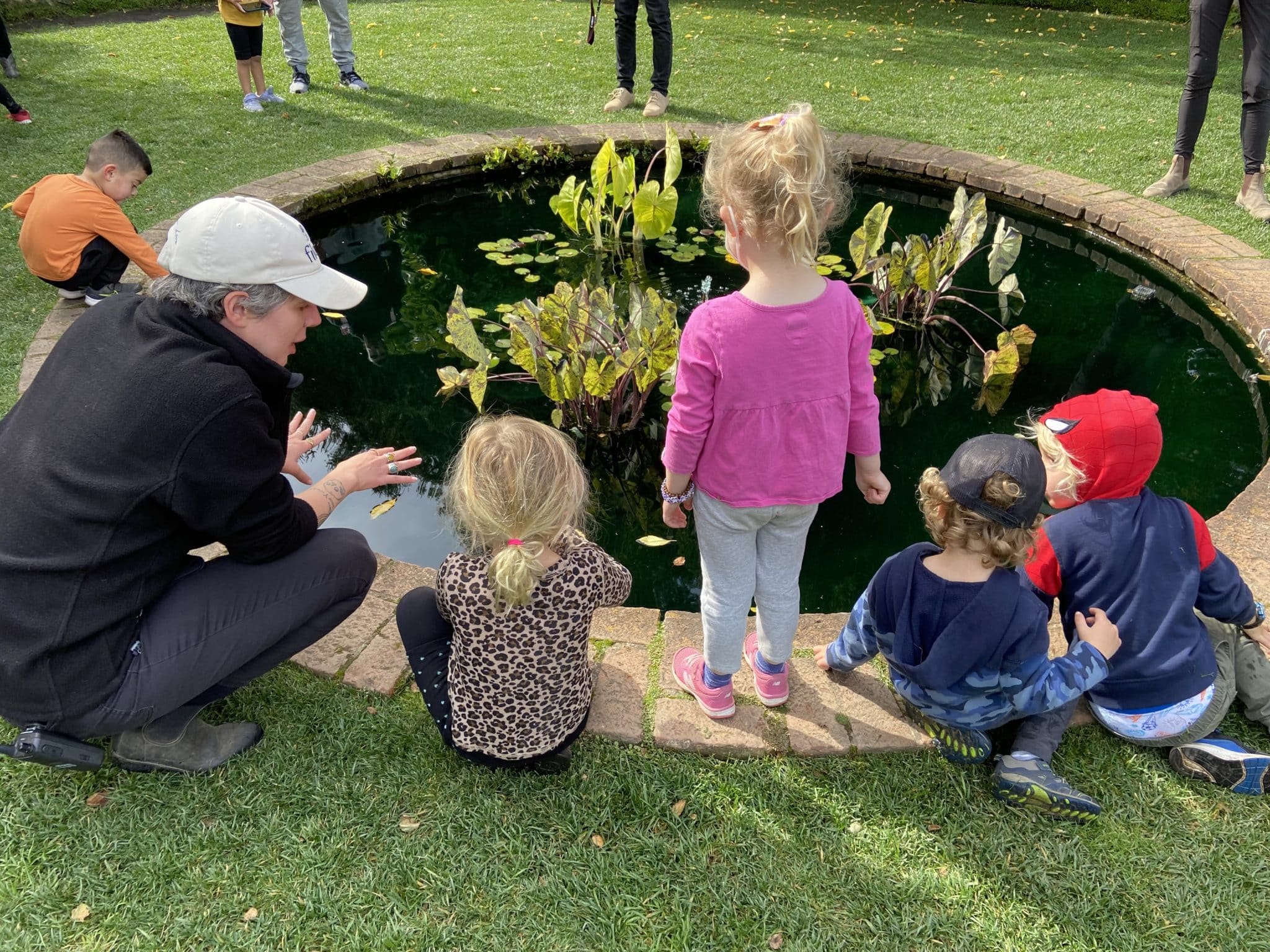 La Honda and Pescadero Preschools on a fall field trip. Tasting apples and honey in the Orchard. Making artwork on the leaf loom with fall leaves.