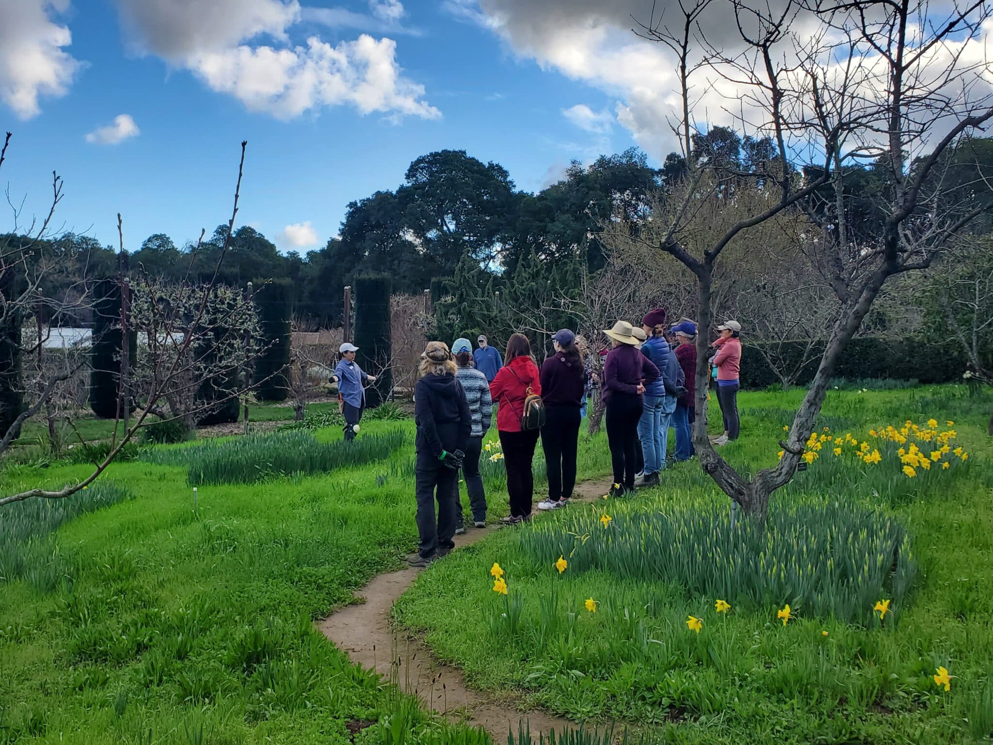 Filoli Horticulture Production Manager Jackie Salas leads a talk in the Family Orchard for Service Learning volunteers on how to prepare a garden for Spring.