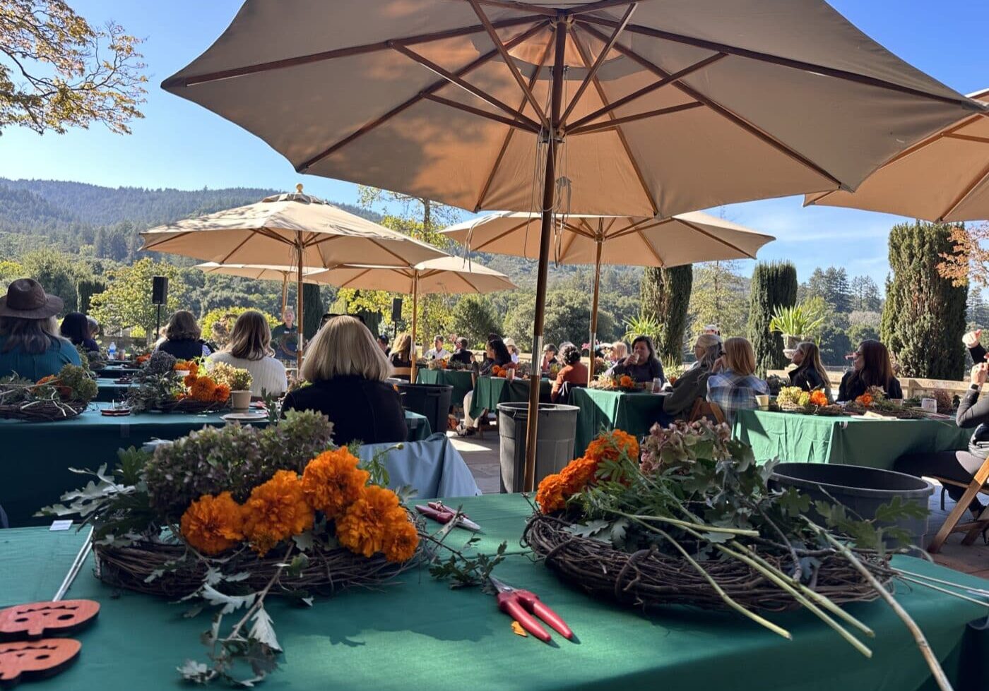 2023 Fall Flora Party on the Ballroom Terrace. Participants decorate wreaths with fall foliage and flowers.