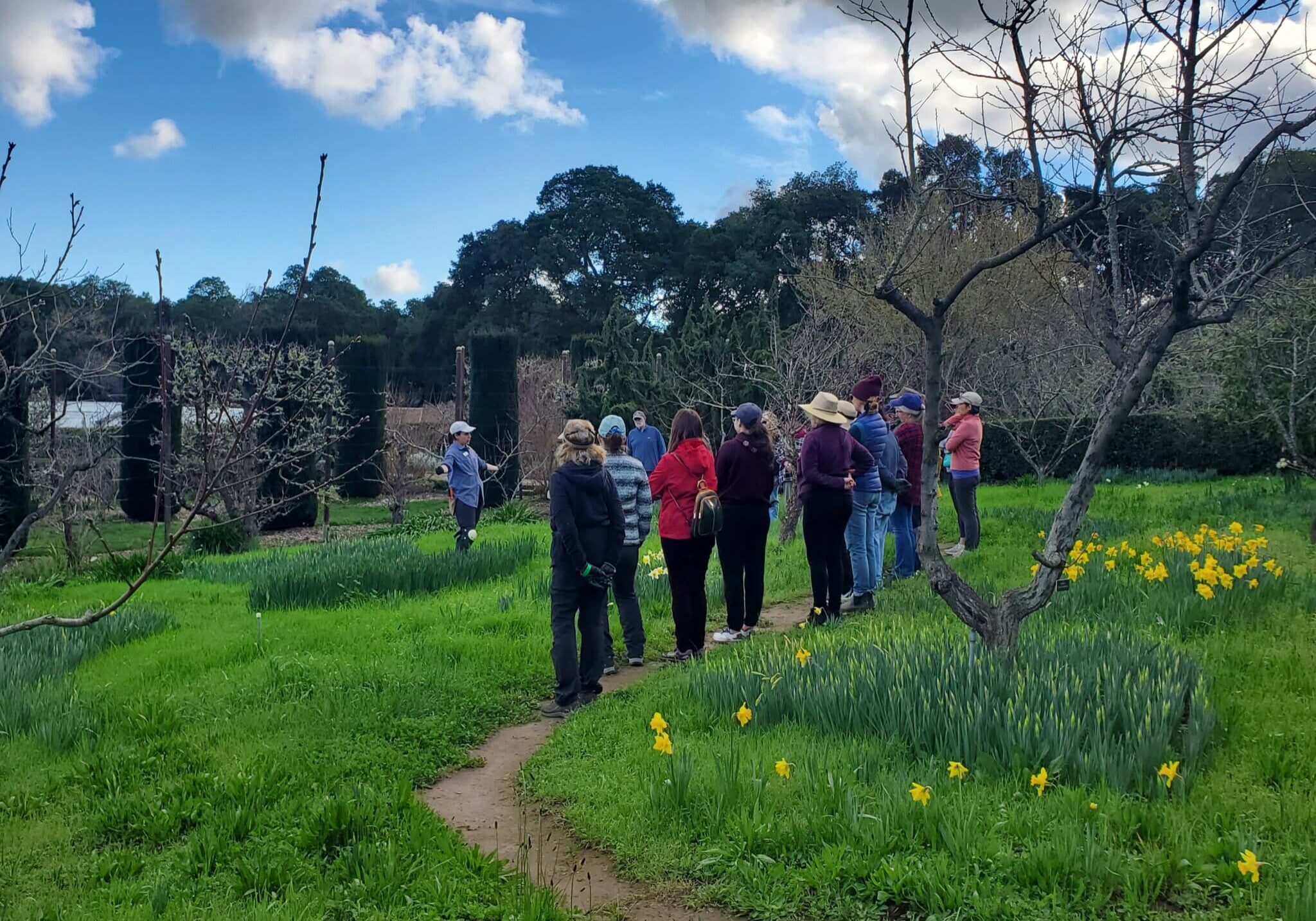 Filoli Horticulture Production Manager Jackie Salas leads a talk in the Family Orchard for Service Learning volunteers on how to prepare a garden for Spring.