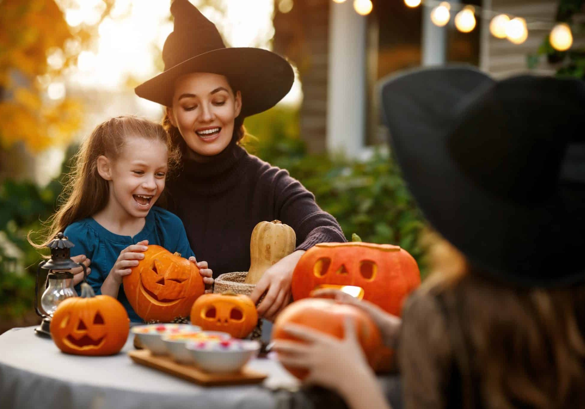 Happy,Family,Preparing,For,Halloween.,Mother,And,Children,Carving,Pumpkins